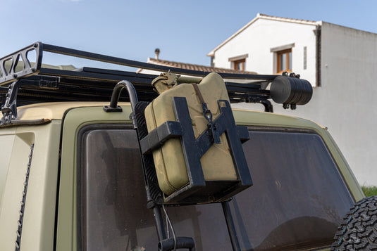 metal fuel can mounted to outside of overlanding car