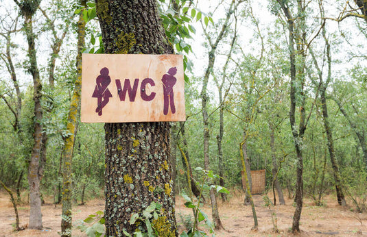 outdoor_sign_on_tree_of_man_woman_restroom_camping