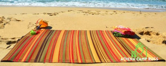 Earthy colored Athena Camp Rug laid on the beach