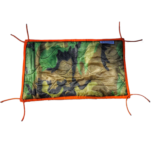 Woobie Hank: Insulated with USGI poncho-liner, serves as a large rag, knee pad, and adventure companion tool.