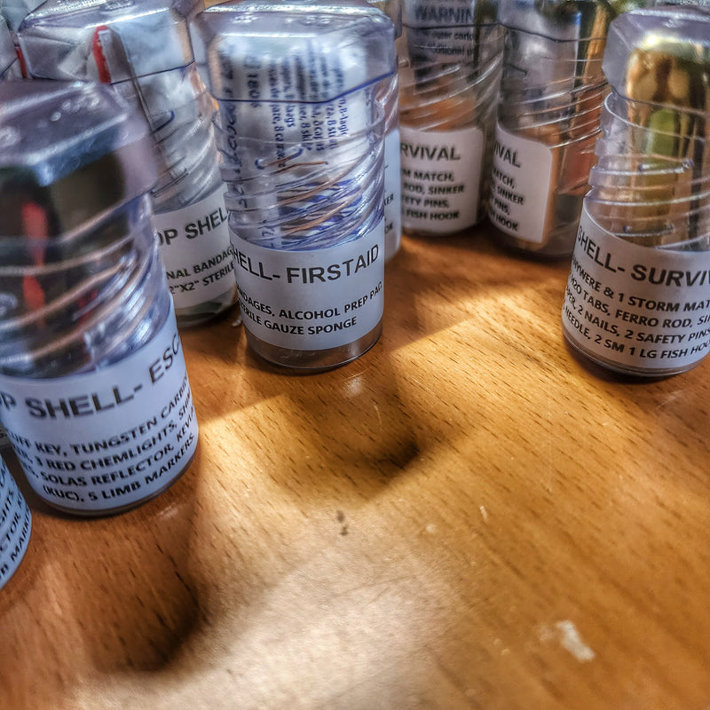 Load image into Gallery viewer, Drop Shell - Polymer Capsule filled with Survival, Escape, and First-Aid Supplies.
